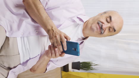 Vertical-video-of-The-old-man-on-the-phone.